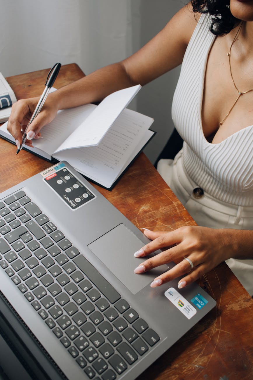 hands of a woman working on a laptop